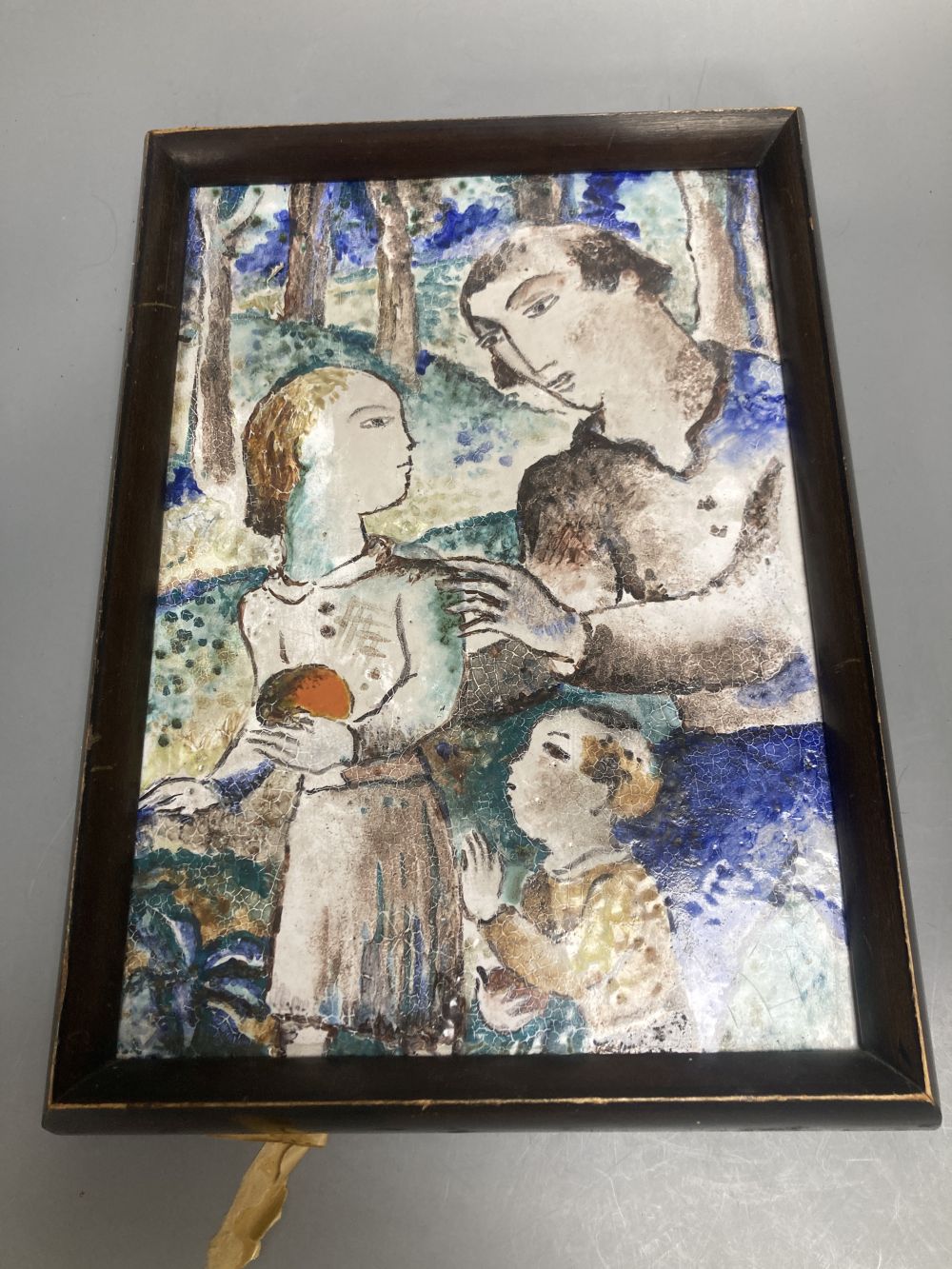 A Continental ceramic tin glazed pottery tile, painted with a young family, unsigned, 29 x 21cm